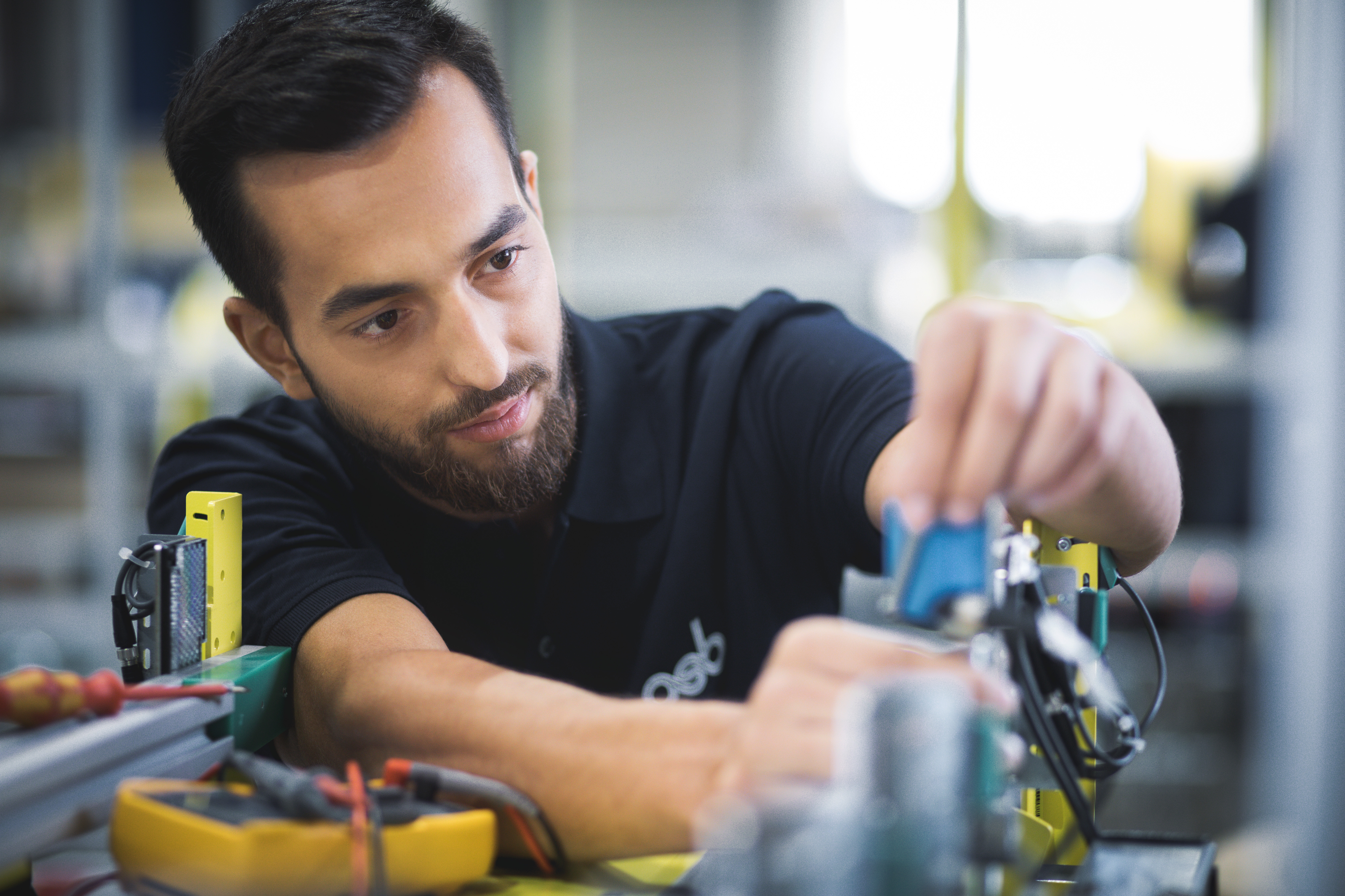 Beispielbild Mechatroniker (m/w/d) bei der Arbeit an Elektronikkomponenten